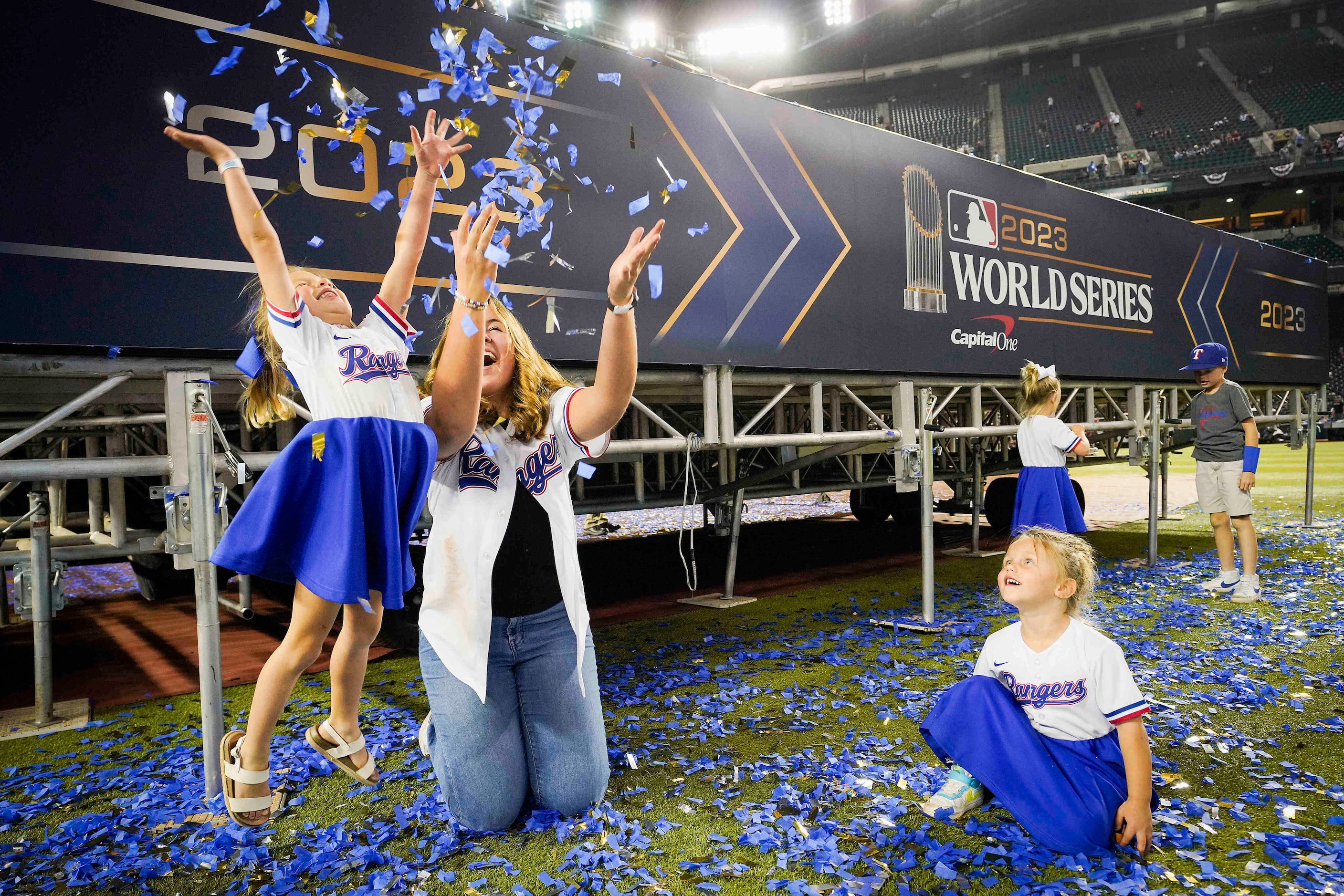 Cate Young, wife of Texas Rangers general manager Chris Young, plays with pitcher Jacob...