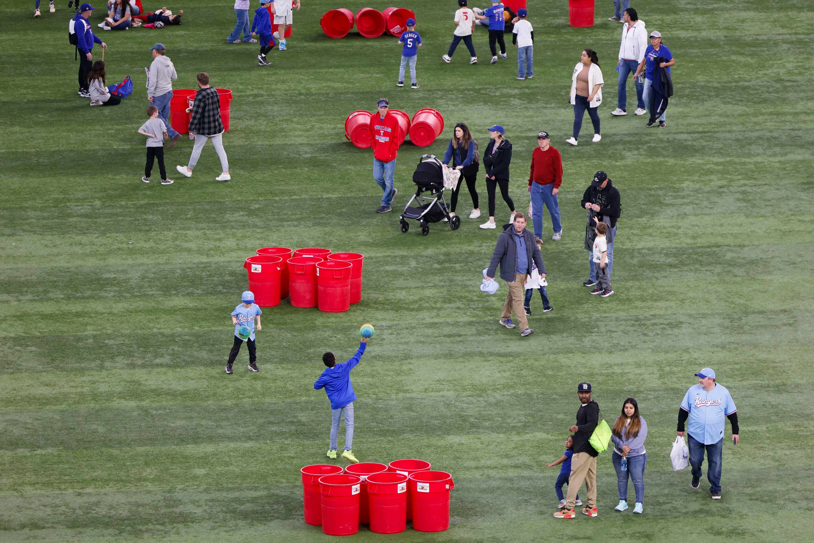 Fans roam around the field and engage in activities during Texas Rangers Fan Fest on,...
