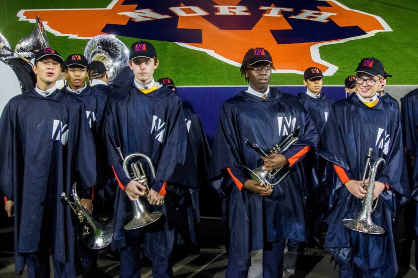 McKinney North High School marching band waits to take the field before halftime during a...