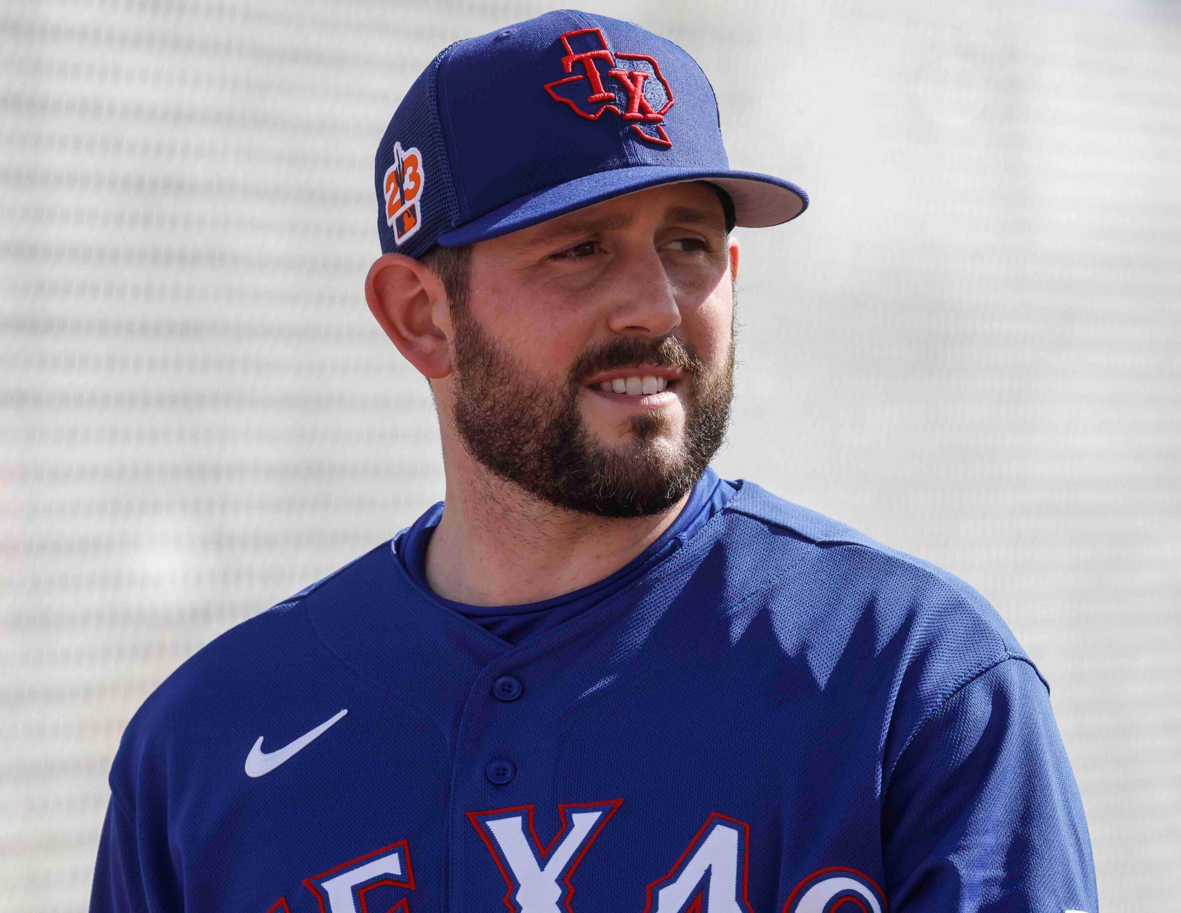 Texas Rangers pitcher Dominic Leone heads to a practice field during a spring training...