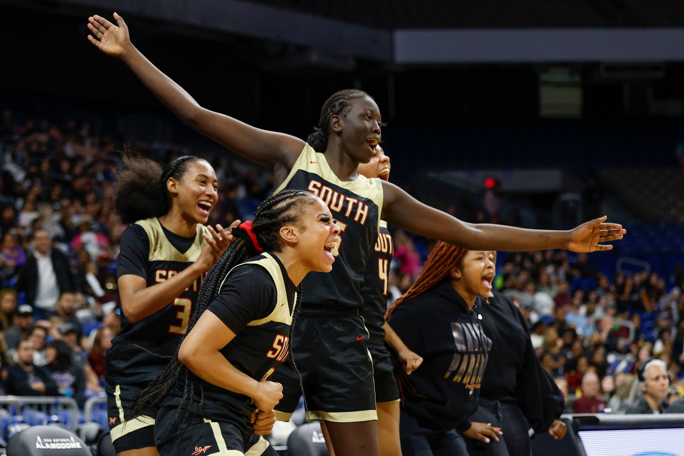 South Grand Prairie center Adhel Tac (15) and South Grand Prairie guard Victoria Dixon (10)...