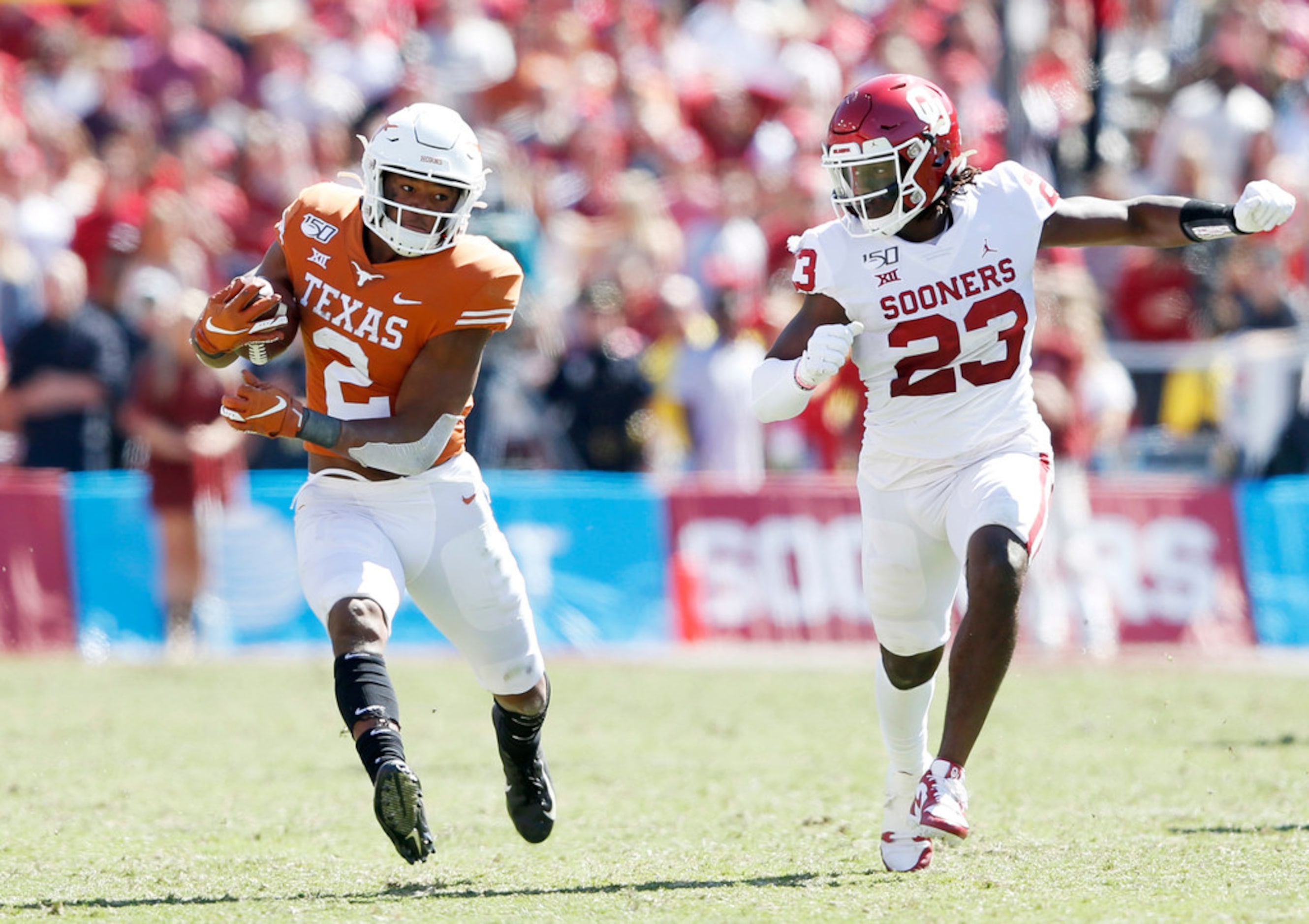 Texas Longhorns quarterback Roschon Johnson (2) runs up the field as Oklahoma Sooners...