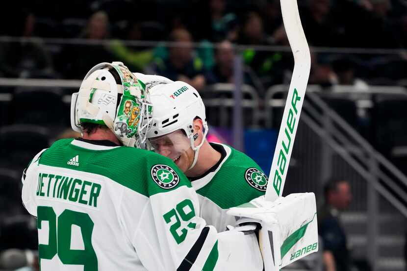 Dallas Stars goaltender Jake Oettinger, left, is greeted by defenseman Esa Lindell after the...