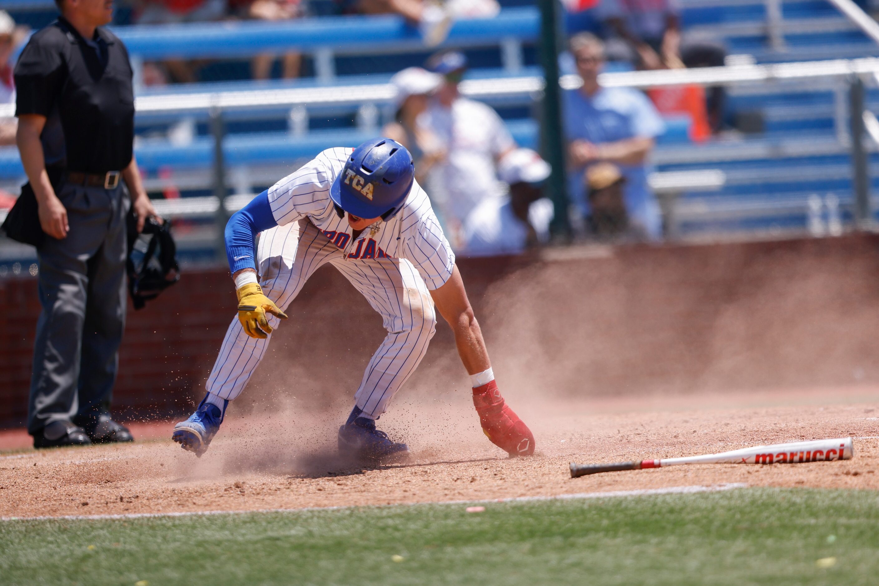 Trinity Christian’s Samuel Jenkins (10) slides into home in the fourth inning against...