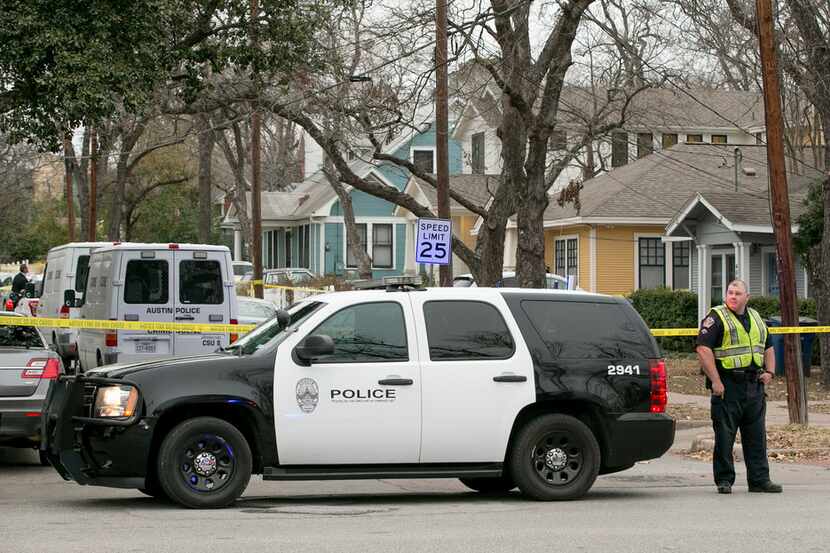 An Austin police officer guards the scene of an officer-involved shooting on Avenue G near...
