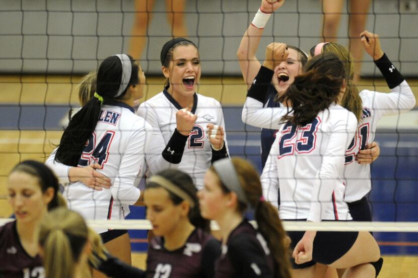 Allen players celebrate after winning a point over Plano during a Class 5A high school...