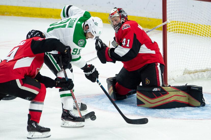 Ottawa Senators defenseman Mark Borowiecki steals the puck away from Dallas Stars centre...