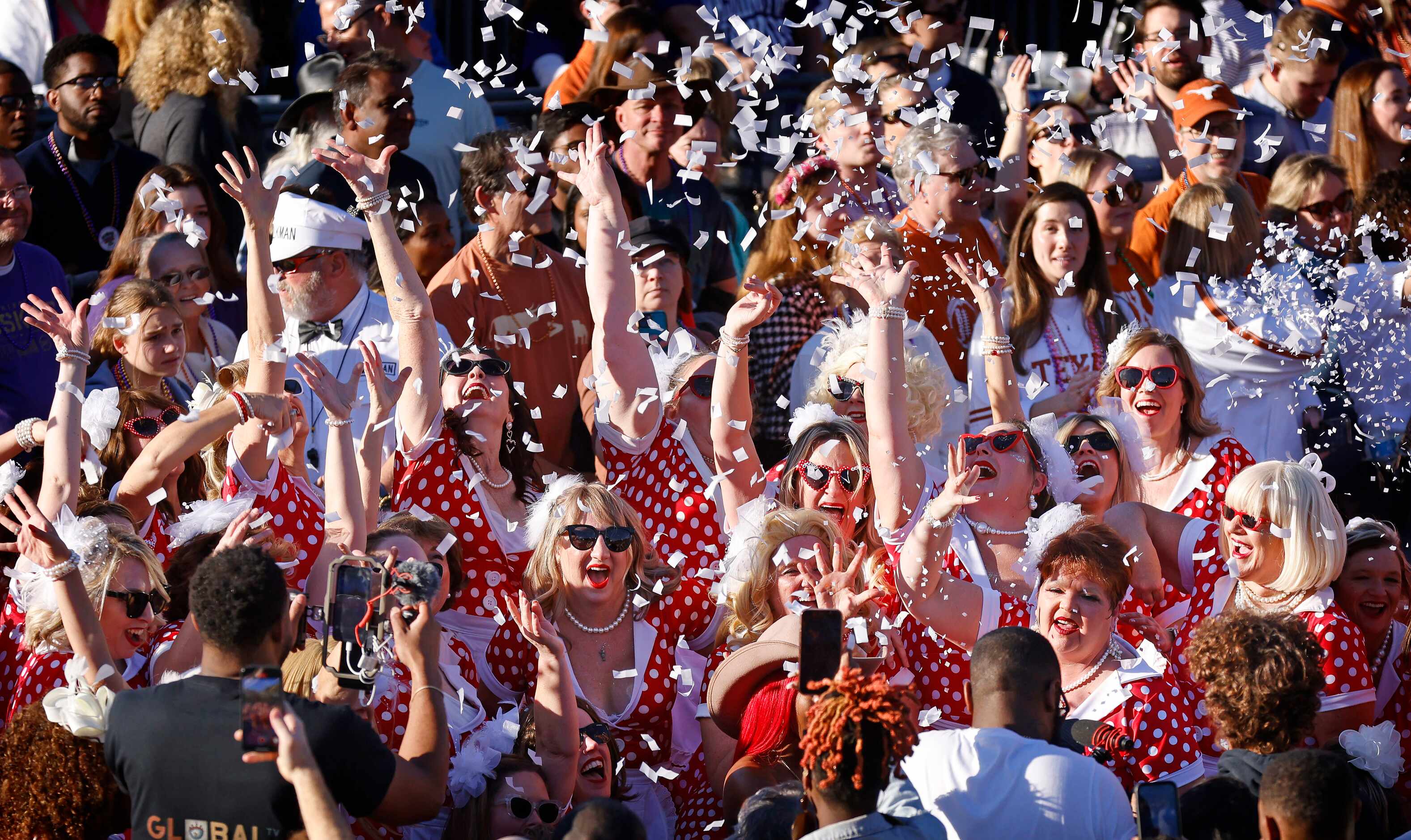 Members of the Mande Milkshakers toss confetti at the end of their performance in the Mardi...