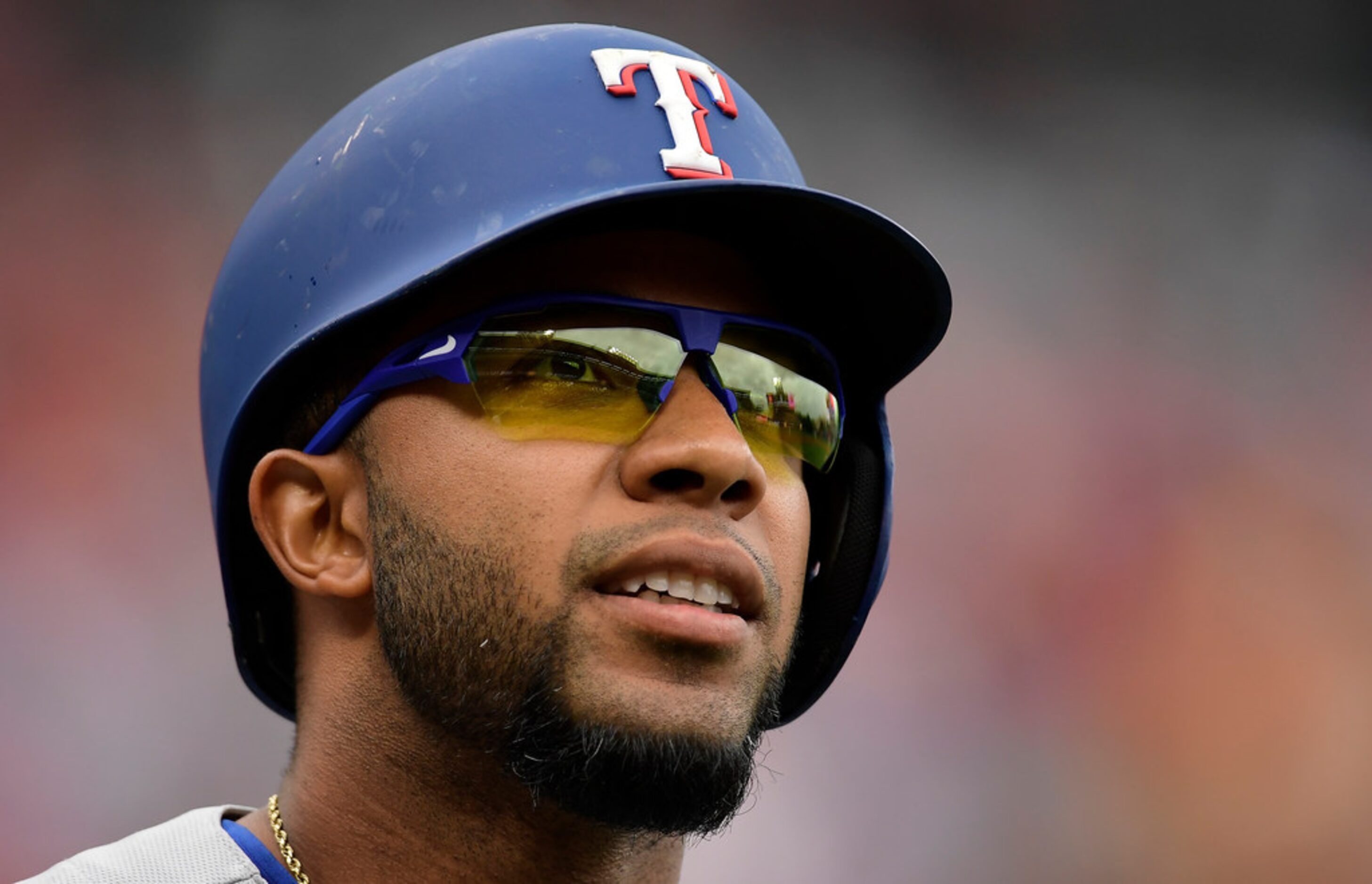 Texas Rangers' Elvis Andrus walks back to the dugout after striking out during the first...