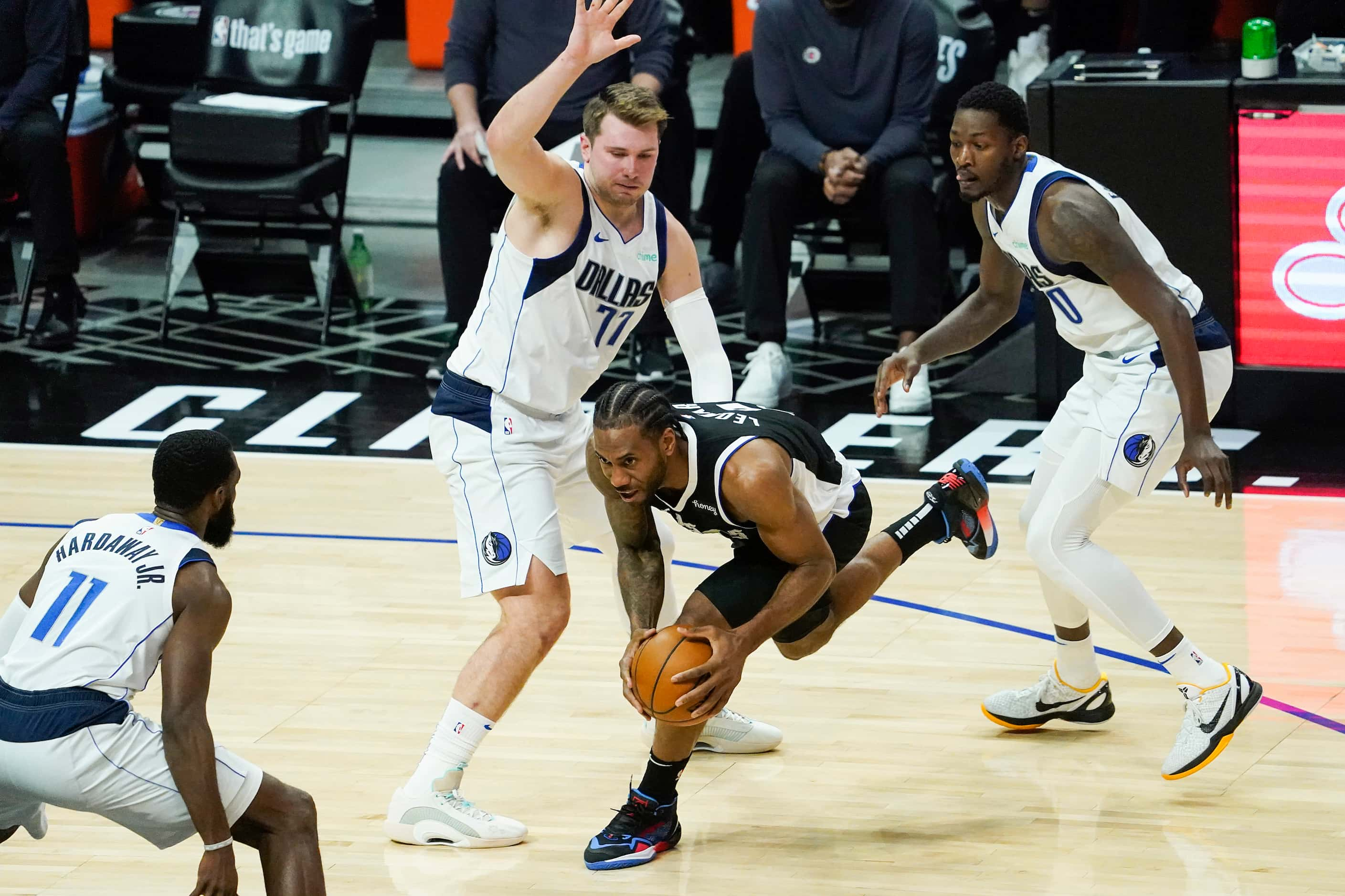 LA Clippers forward Kawhi Leonard (2) tries to drive between Dallas Mavericks guard Luka...