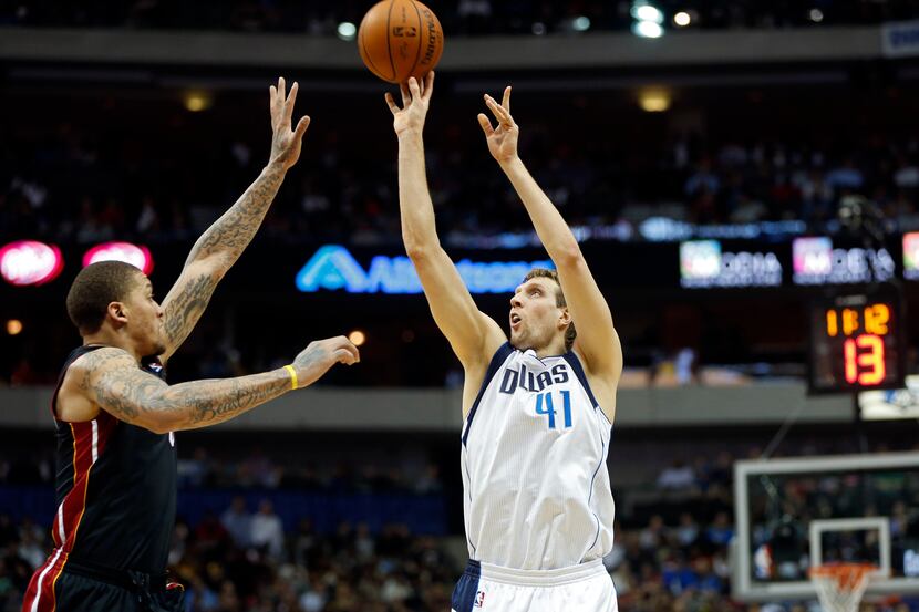 Dallas Mavericks power forward Dirk Nowitzki (41) takes a shot in front of a leaping Miami...