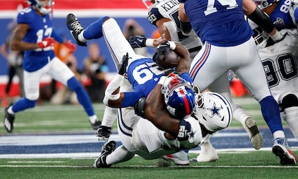 Dallas Cowboys defensive tackle Mazi Smith (58) flips over New York Giants running back...