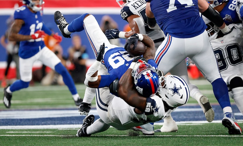 Dallas Cowboys defensive tackle Mazi Smith (58) flips over New York Giants running back...