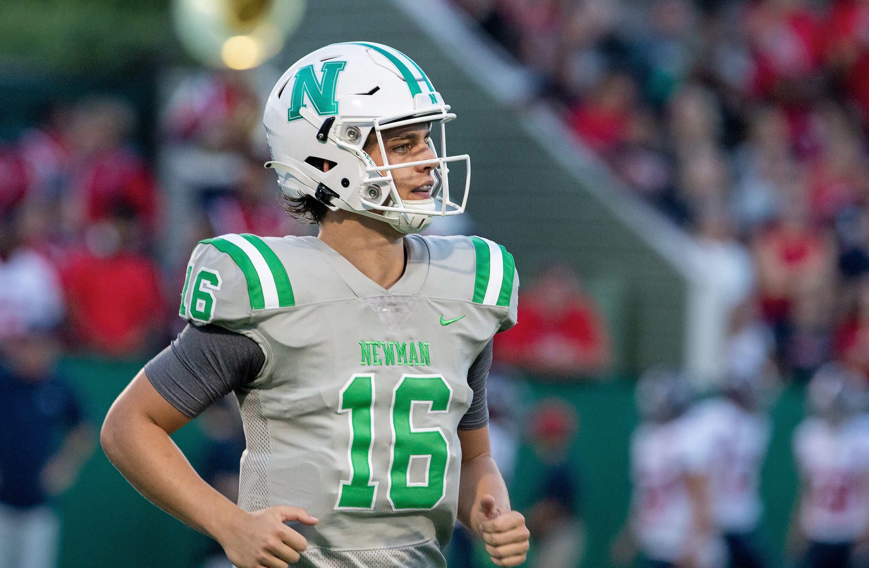 Arch Manning trots off they field after throwing a TD pass early in the game as Newman High...