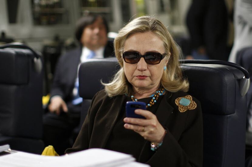 Hillary Clinton, while secretary of state, checks her Blackberry inside a C-17 military...