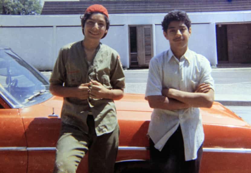 David Rodriguez, 13, (left) and his brother Santos Rodriguez, 12, stood by a relative's car...