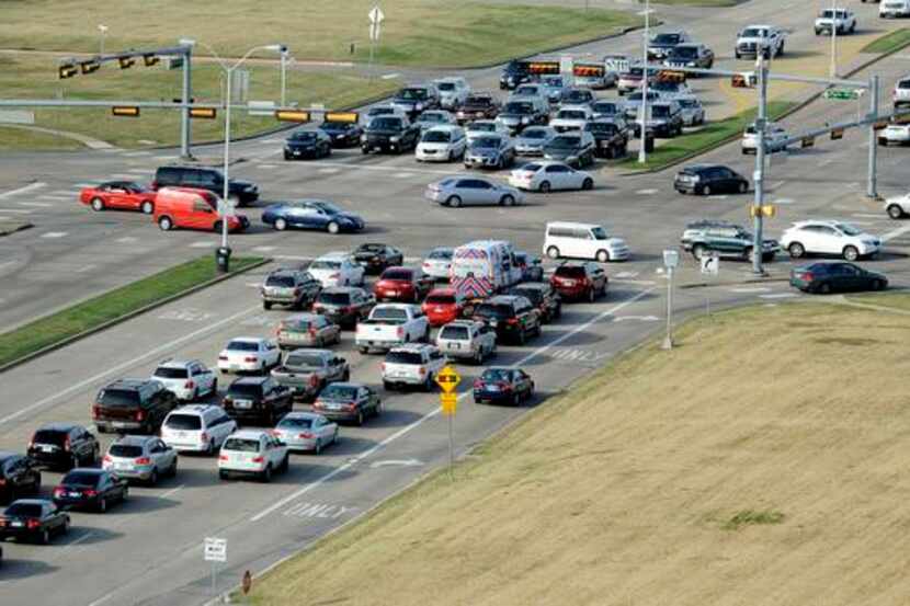 Cars hit afternoon traffic at the intersection of Preston Road and Park Boulevard in Plano...