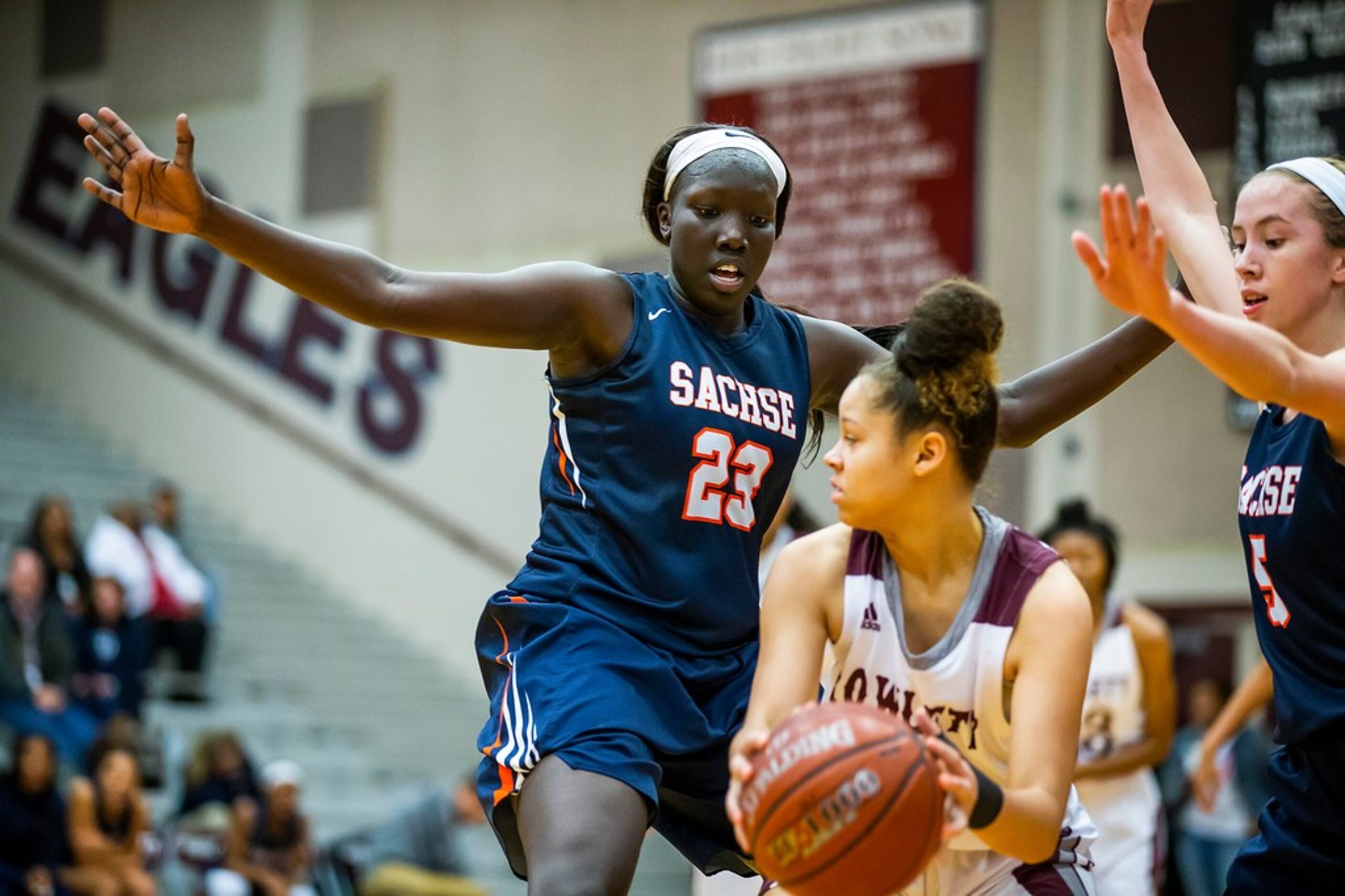 Sachse center Adhel Tac (23) and guard Avery Crouse (5) trap Rowlett guard Mallorie Miller...