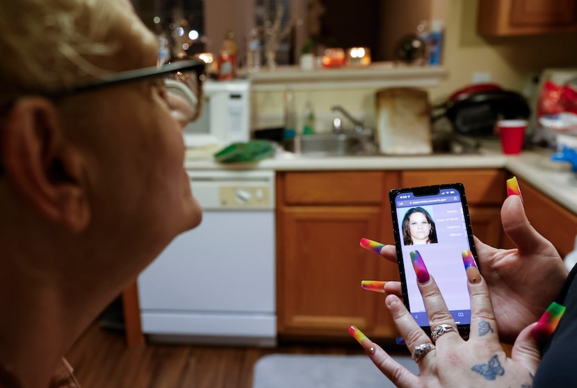 Sydney Navarro (right) shows her mother her mug shot in September 2022 in Fort Worth. Sydney...