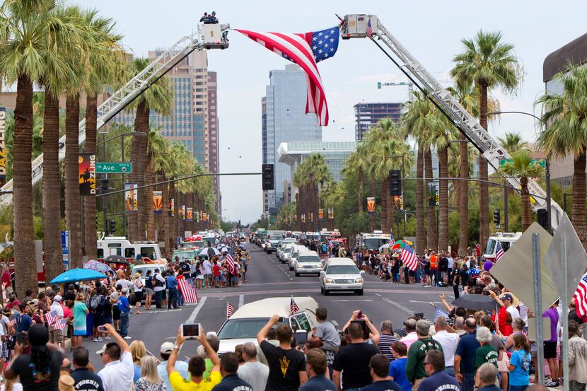 A procession of 19 hearses drives through Phoenix on Sunday to honor the Hotshot...