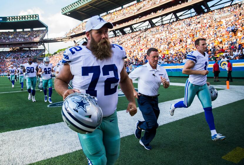 Dallas Cowboys center Travis Frederick (72) walks off the field at halftime of an NFL...