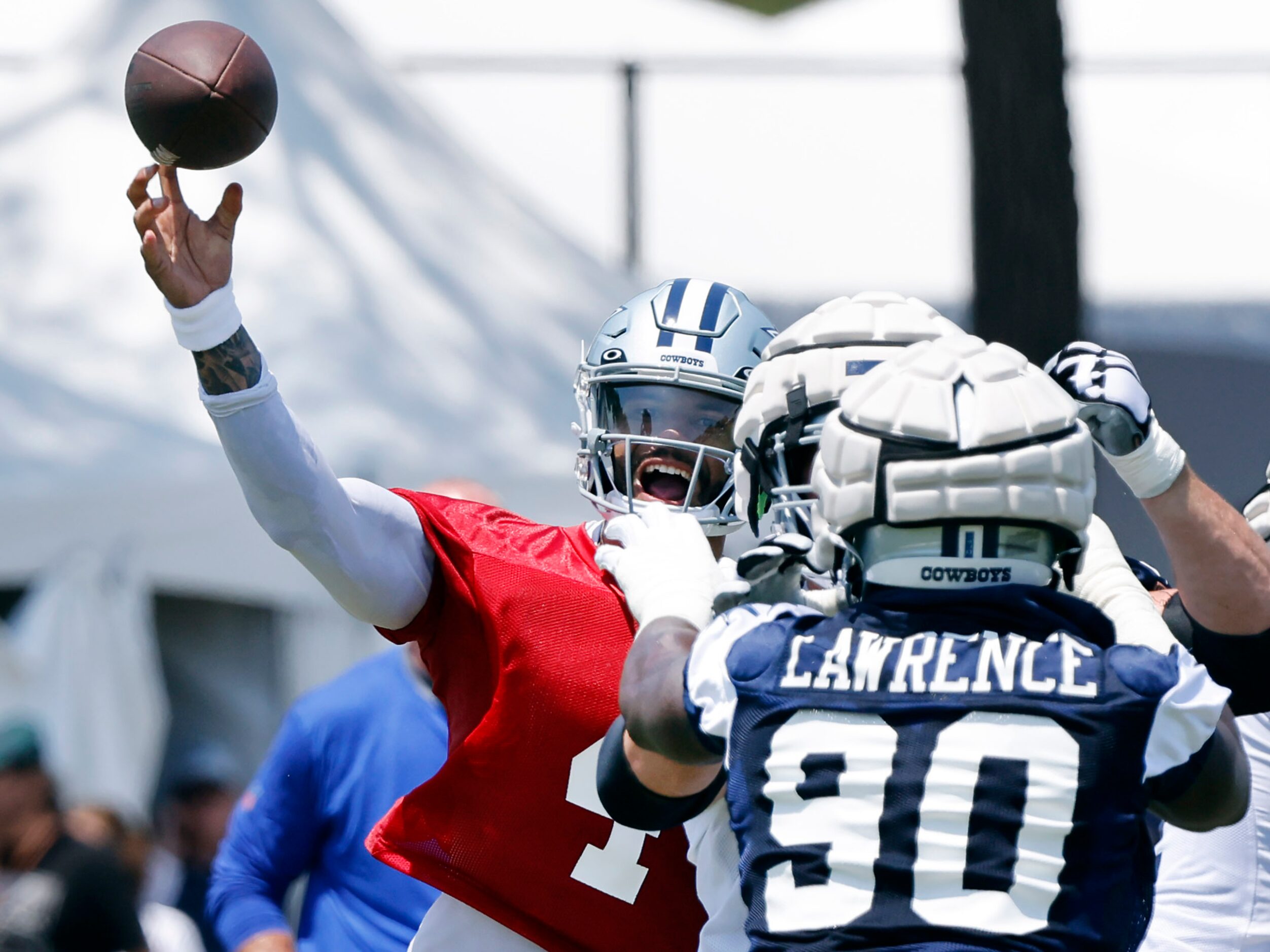 Dallas Cowboys quarterback Dak Prescott (4) throws a pass over defensive end Demarcus...