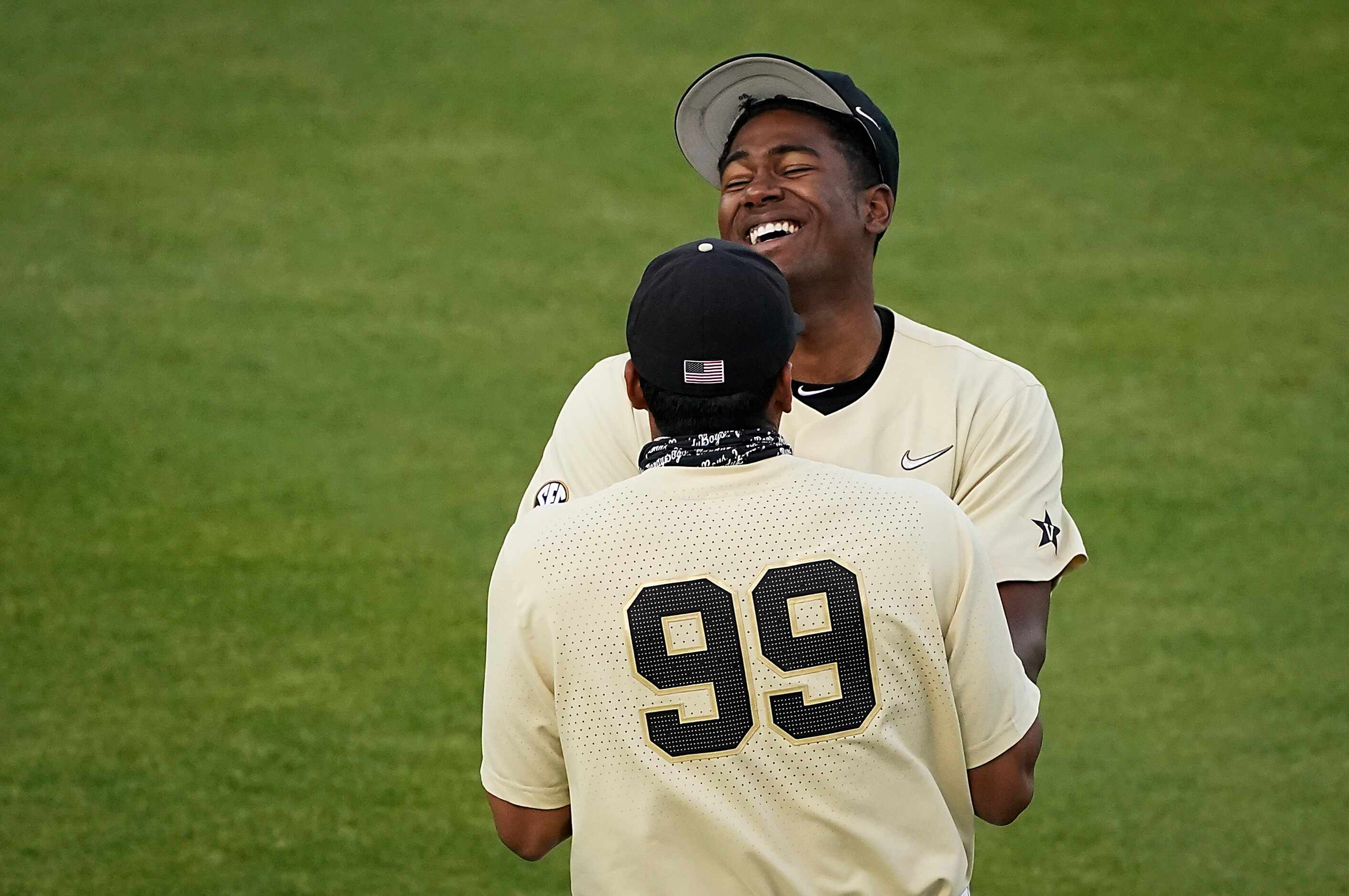 Vanderbilt pitcher Kumar Rocker laughs with infielder Jayson Gonzalez during an NCAA...
