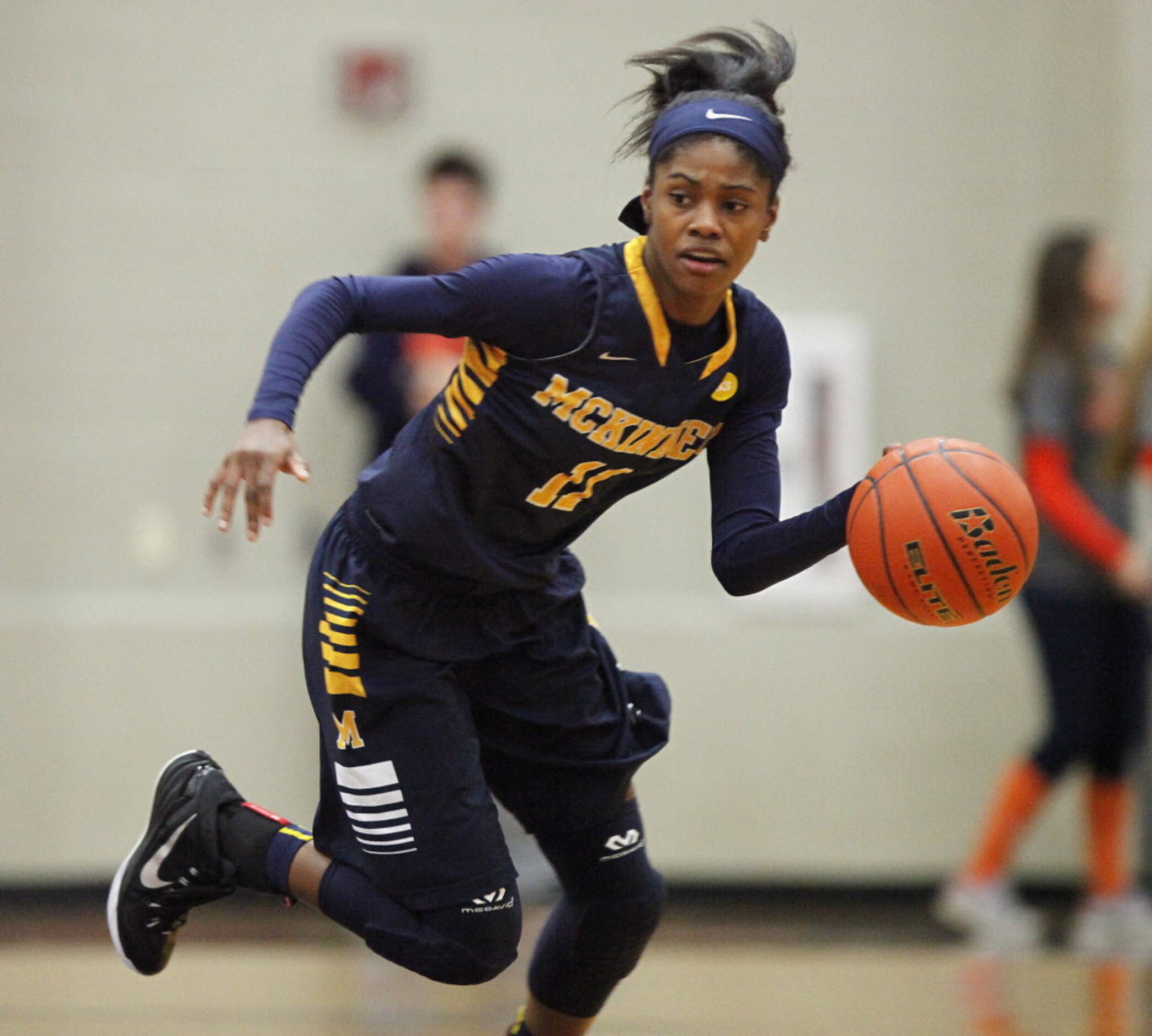 McKinney guard Quincy Noble (11) dribbles the basketball up the floor during the first...