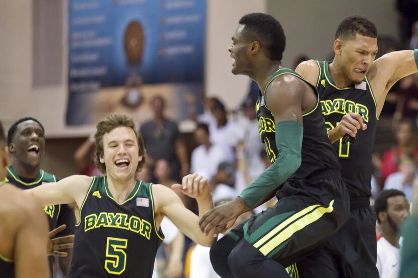 Baylor guard Brady Heslip (5) and his teammates guard Gary Franklin, center, and center...