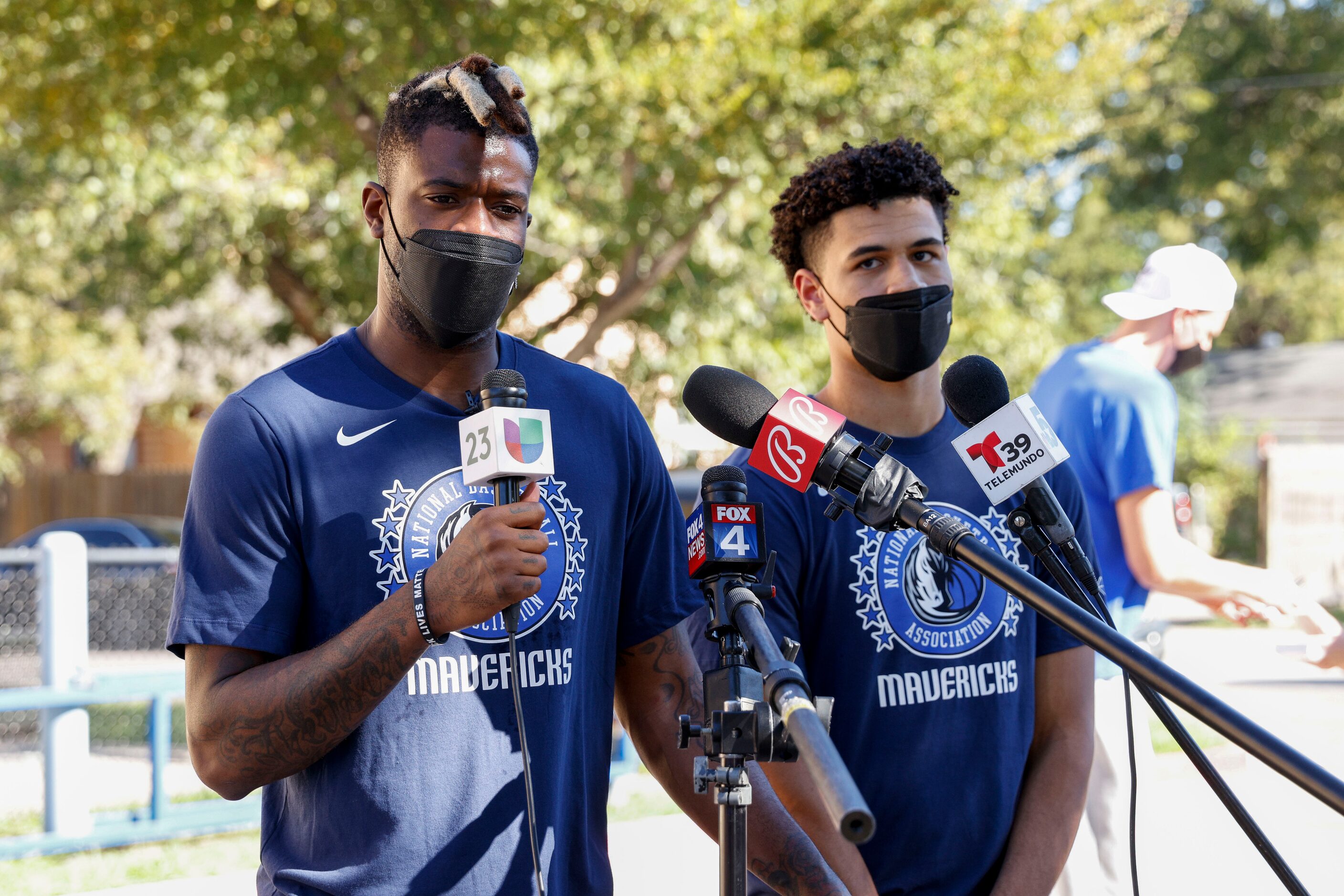 Dallas Mavericks small forward Reggie Bullock (left) and shooting guard Josh Green speak...