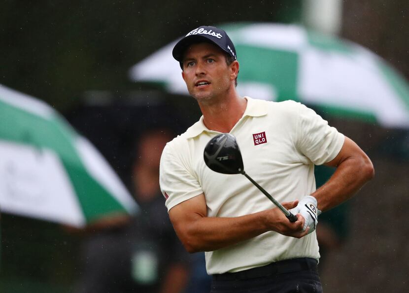 Adam Scott watches his tee shot on the 17th hole during the second round of the Masters...