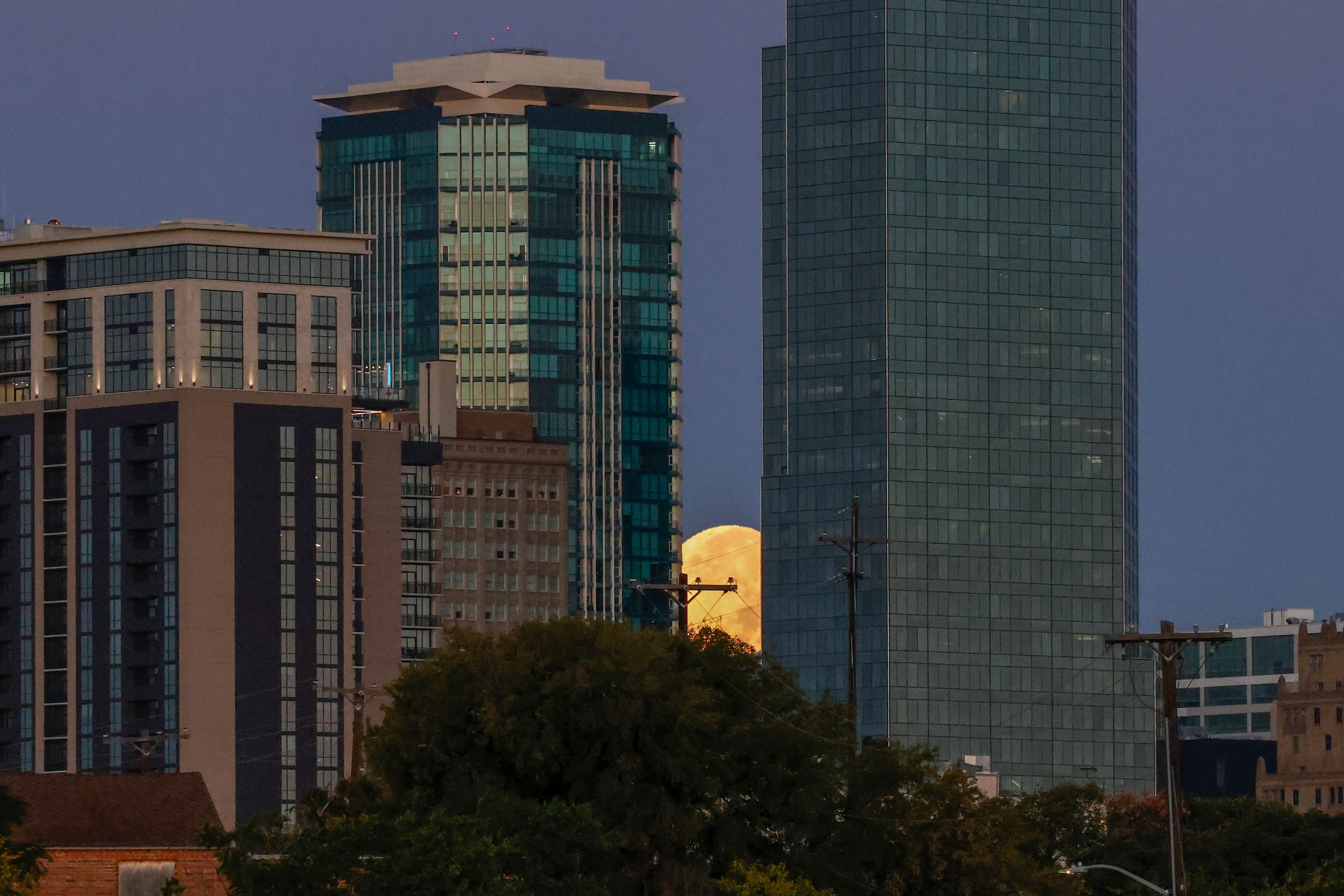 A supermoon sets behind downtown Fort Worth, Thursday, Oct. 17, 2024. A supermoon is a full...