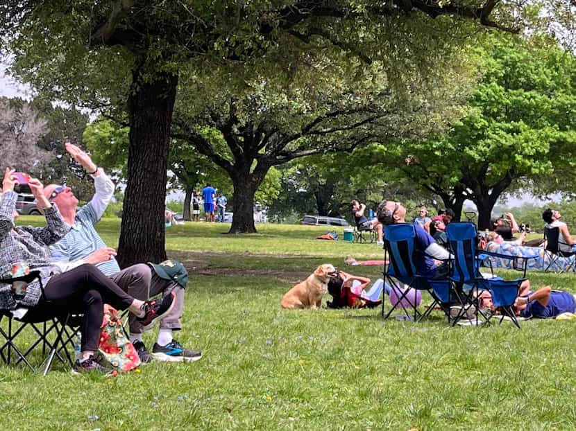 Eclipse spectators at Flag Pole Hill Park in Dallas on Monday as they awaited the moment of...