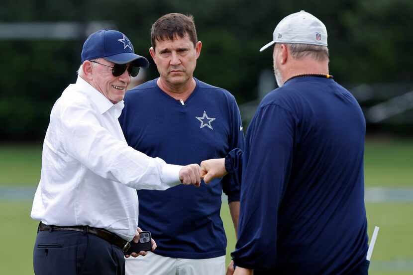Dallas Cowboys owner Jerry Jones (left) fist bumps head coach Mike McCarthy before training...