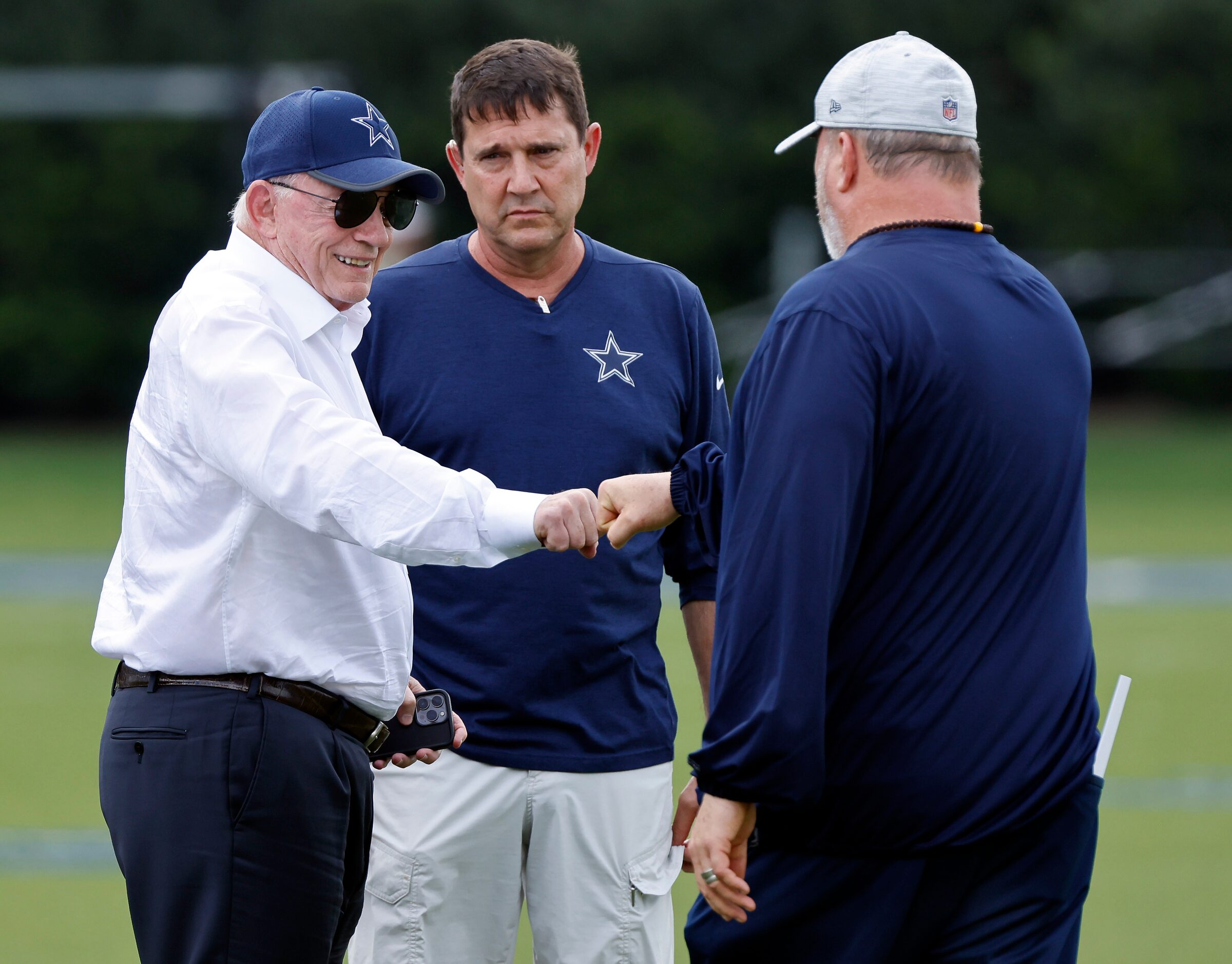 Dallas Cowboys owner Jerry Jones (left) fist bumps head coach Mike McCarthy before training...