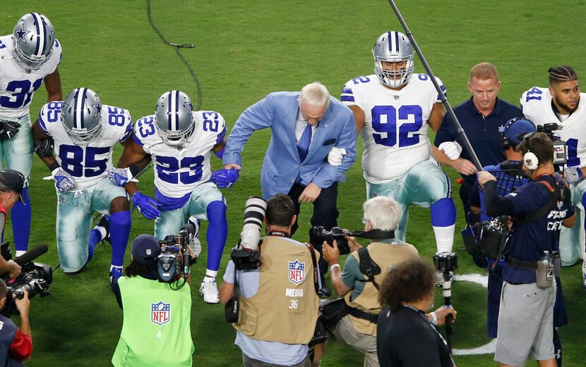 Dallas Cowboys players and staff including owner Jerry Jones and head coach Jason Garrett...