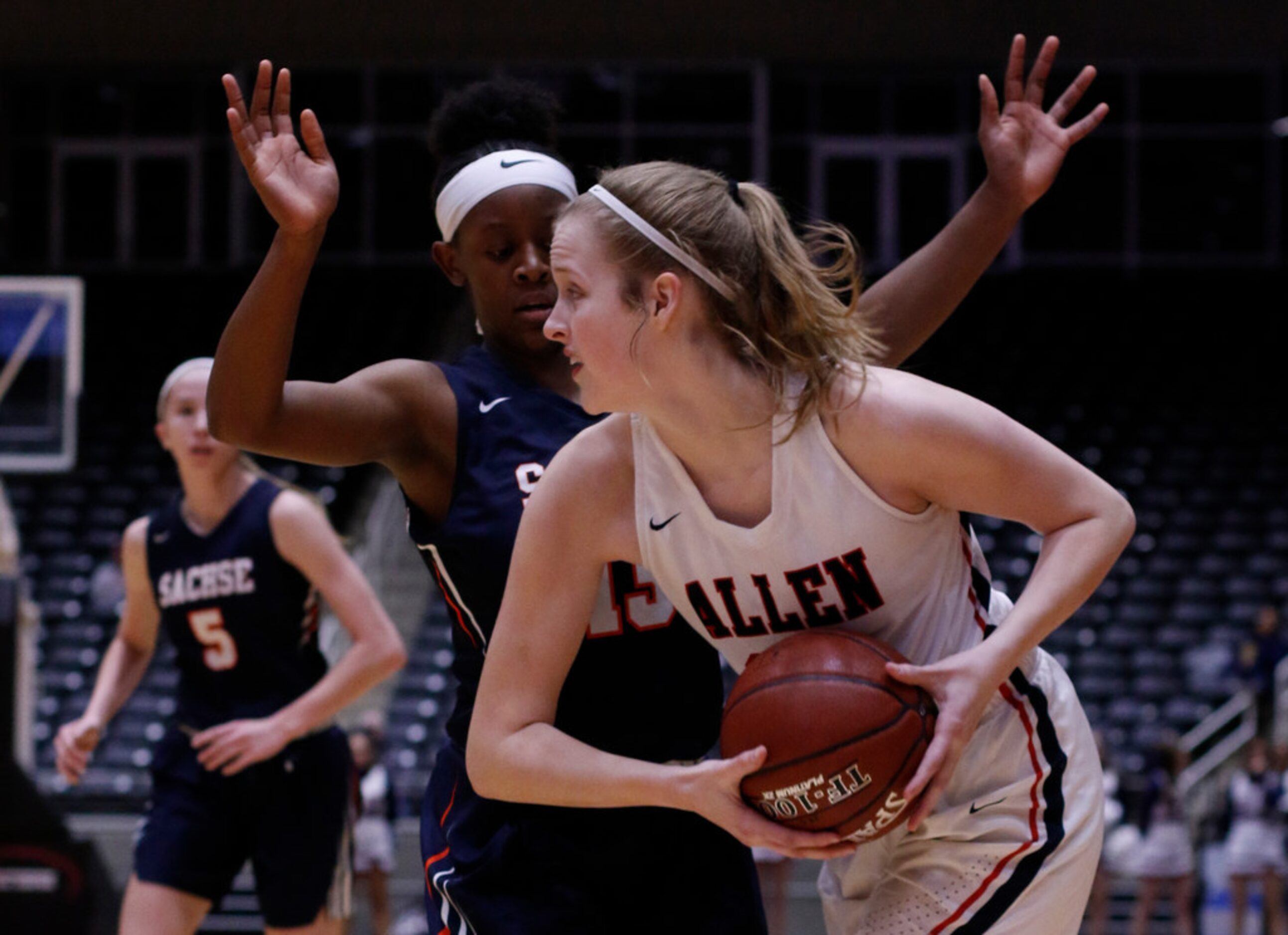 Allen post  Grace Woodruff (33) looks to pass as she is defended by Sachse guard Jayla...