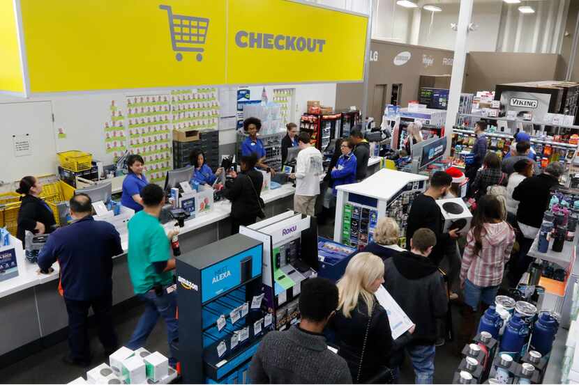The checkout line at Best Buy was packed throughout the day as customers did last-minute...