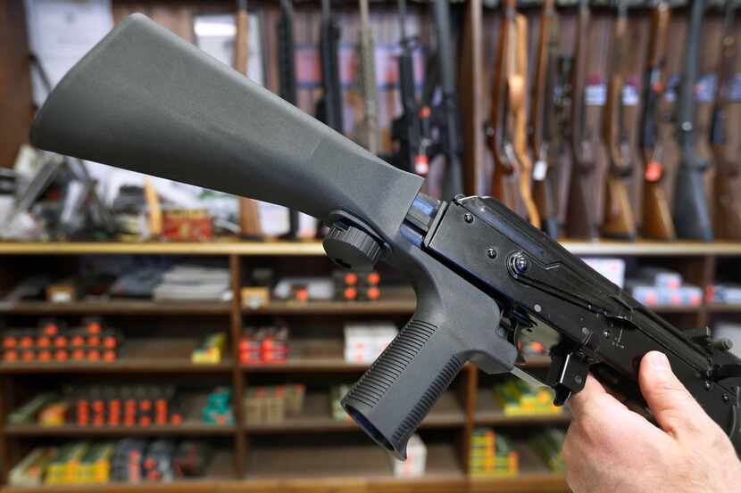 A bump stock device (left) fits on a semi-automatic rifle to increase the weapon's firing...