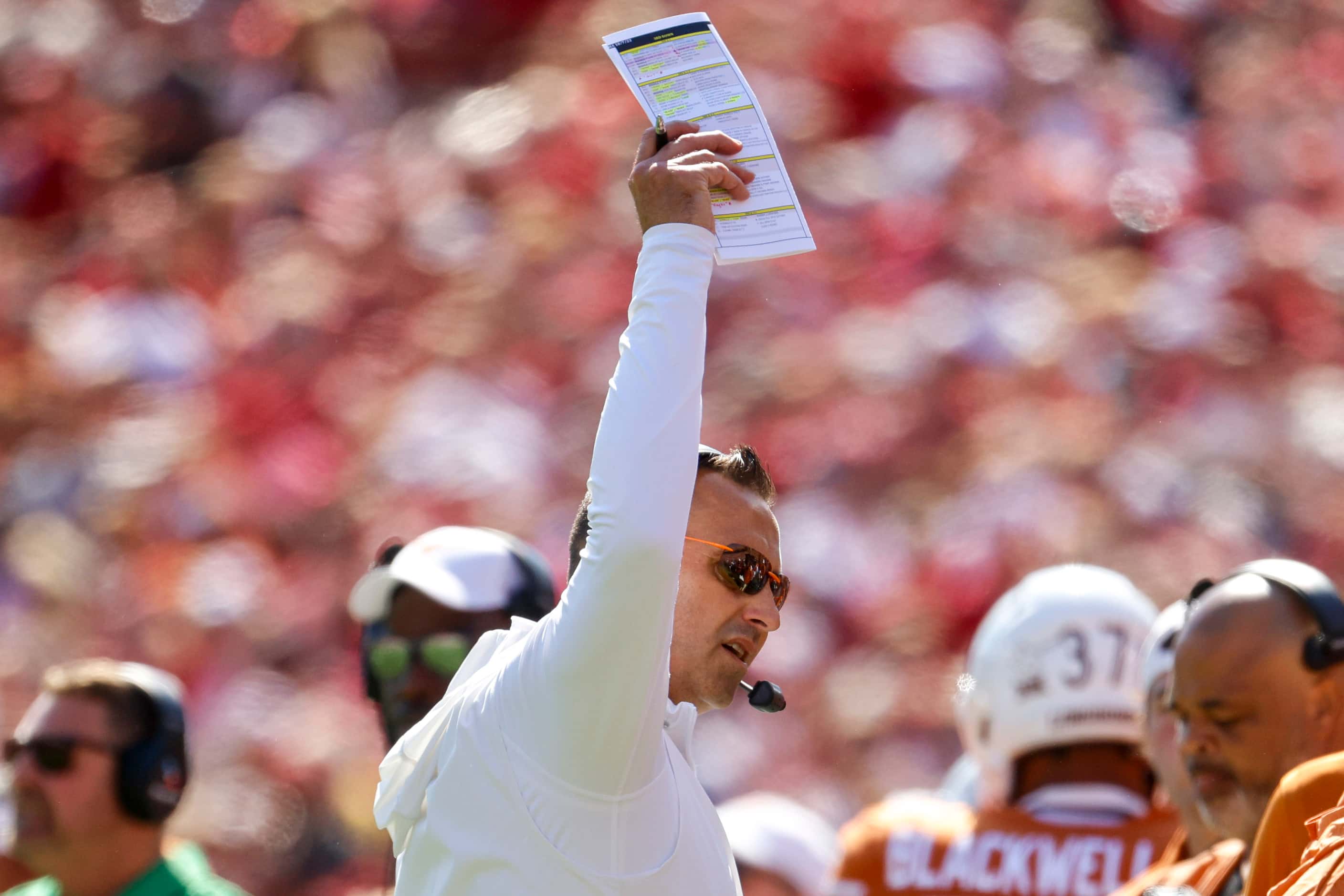 Texas head coach Steve Sarkisian hypes the crowd during the first half of the Red River...