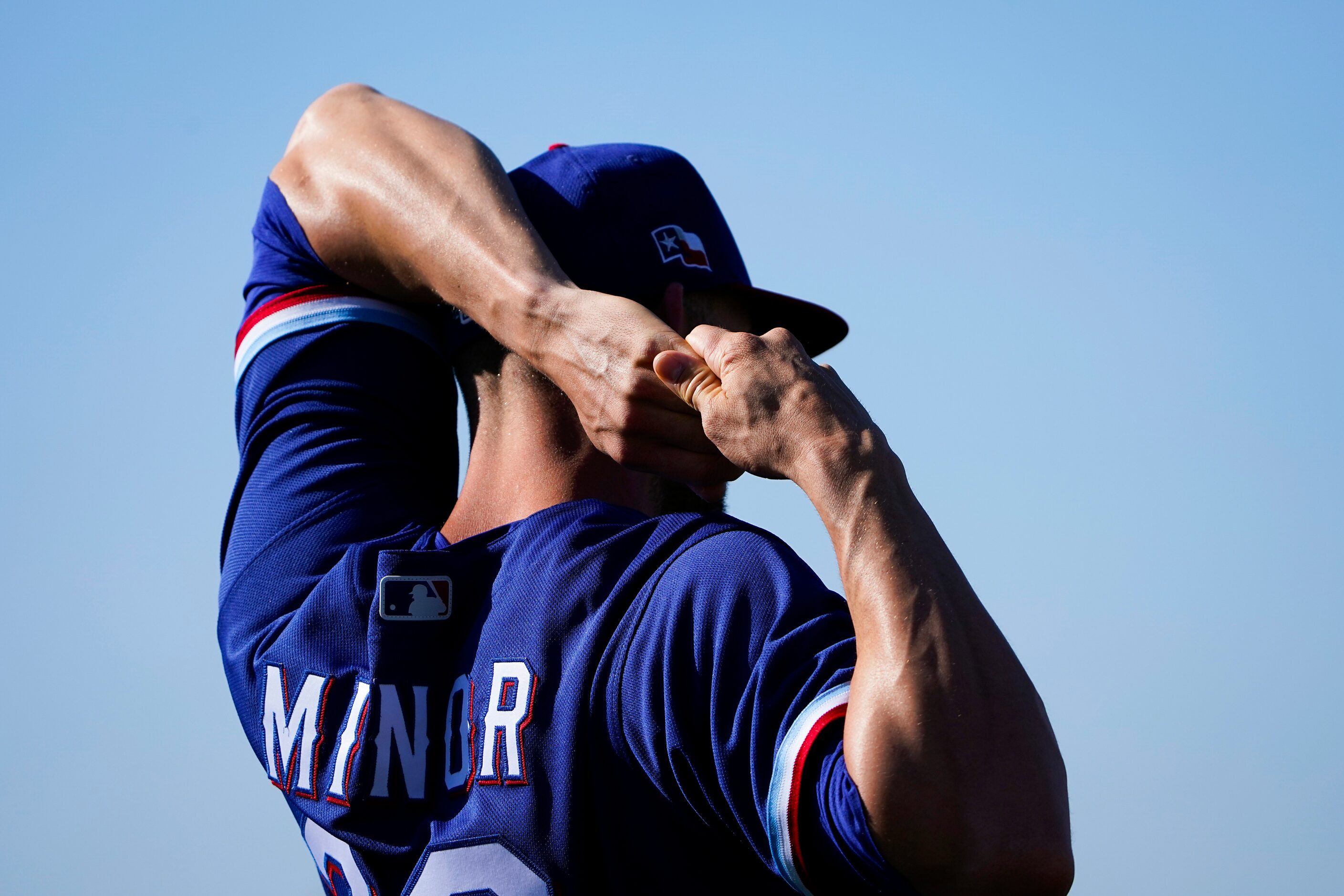 Texas Rangers pitcher Mike Minor stretches during a spring training workout at the team's...