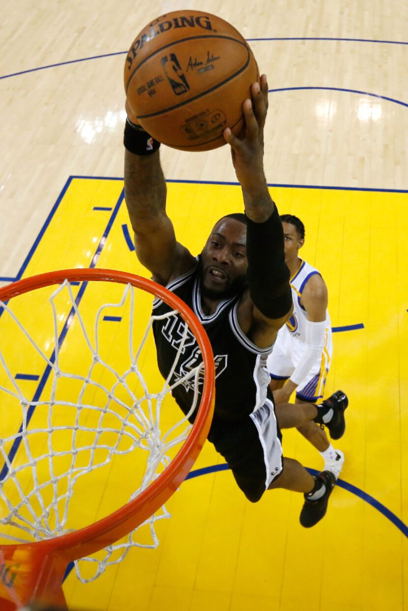 OAKLAND, CA - MAY 16:  Jonathon Simmons #17 of the San Antonio Spurs dunks the ball against...