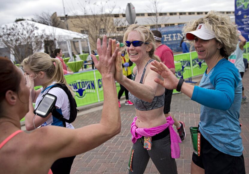 Leann Davenport (center) and Melissa Coleman (right) high-five Jaclyn Garcia as they...