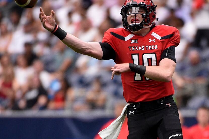 Texas Tech quarterback Alan Bowman (10) throws a pass during the first half of a college...