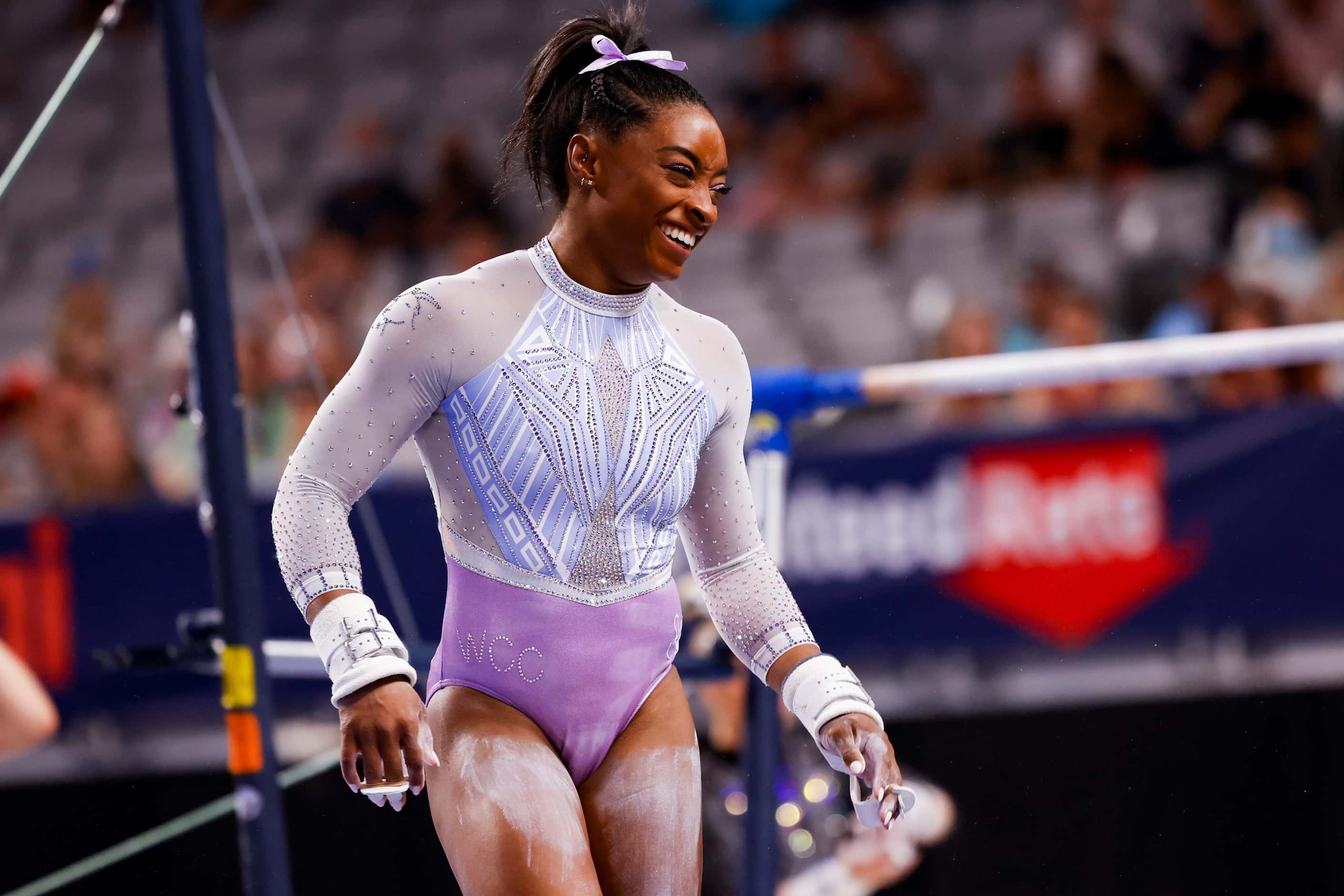 Simone Biles smiles after finishing the uneven bars during day 1 of the senior women's US...