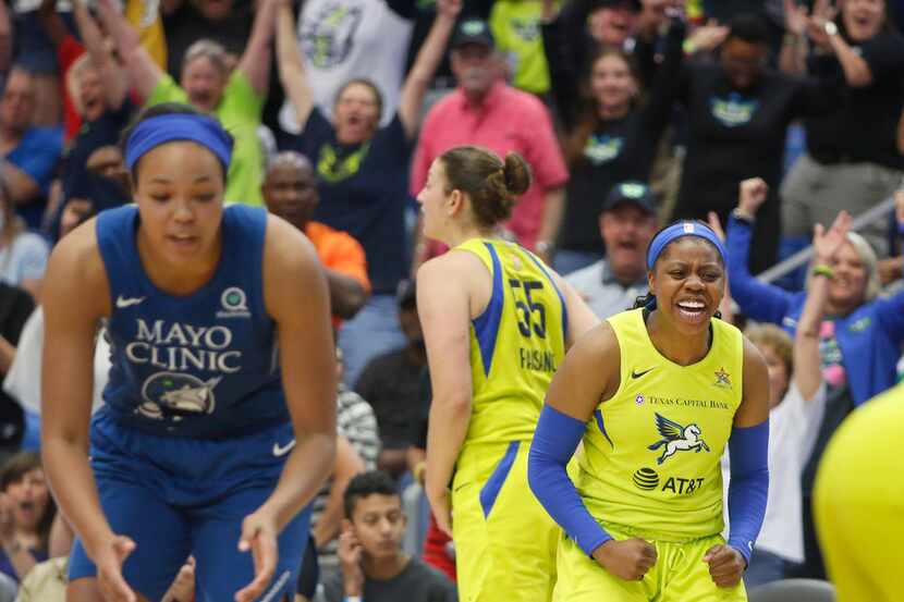 Dallas Wings guard Arike Ogunbowale (24) clenches her fist as she celebrates with teammates...