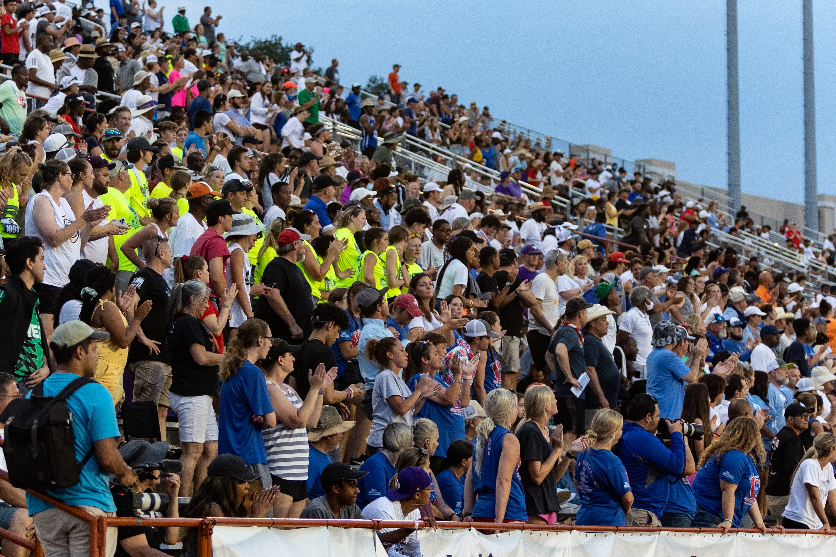 Fans cheer on Natalie Cook of Flower Mound as she tears away from the rest of the field in...