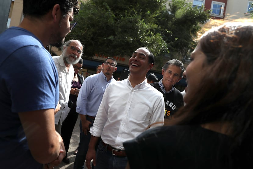 Former U.S. Housing Secretary Julian Castro greets business owners while touring a housing...