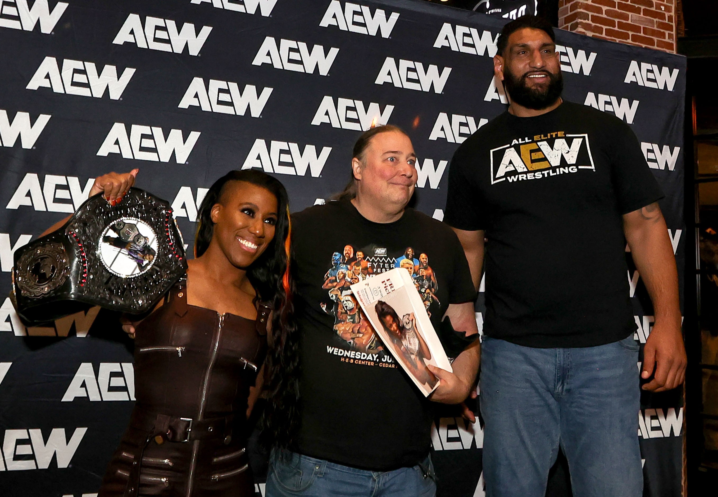 Athena, and Satnam Singh take a photo with a fan at the All Elite Wrestling kickoff party on...