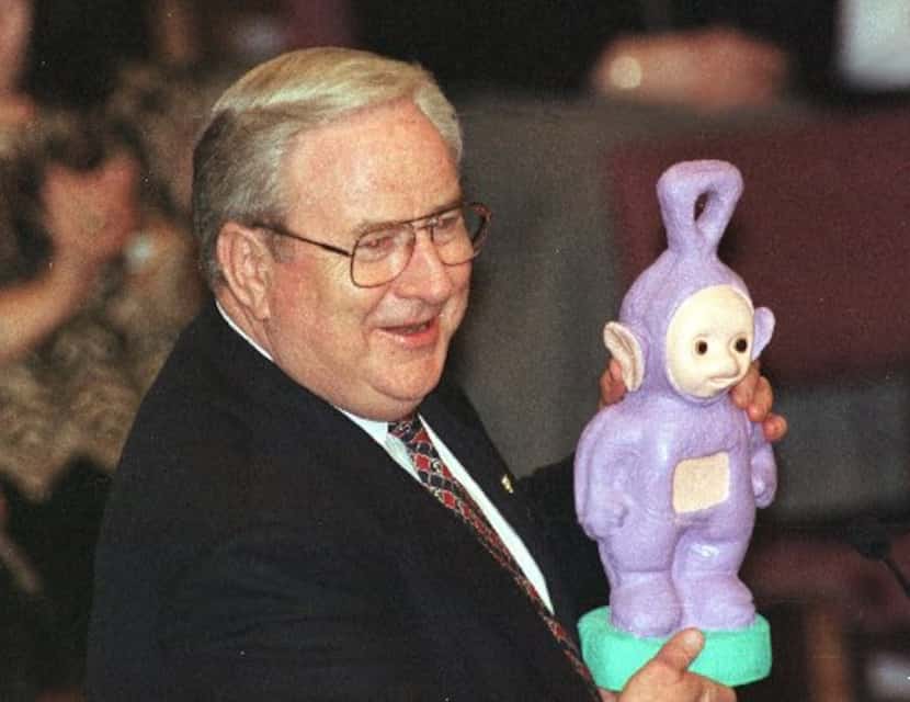Rev. Jerry Falwell holds a Tinky Winky Teletubby presented to him by Rev. Bill Dougherty of...
